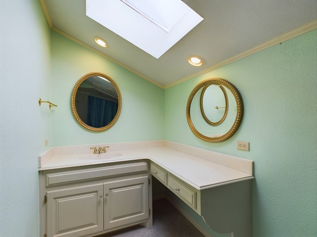 bathroom featuring vaulted ceiling with skylight, vanity, and ornamental molding