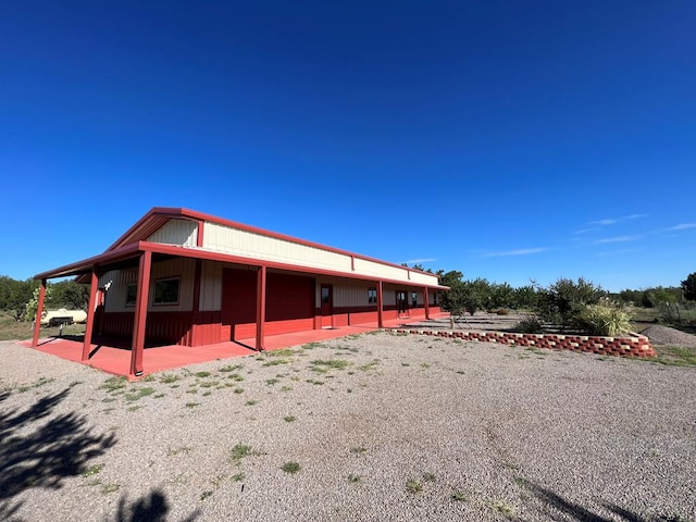 rear view of property featuring a patio