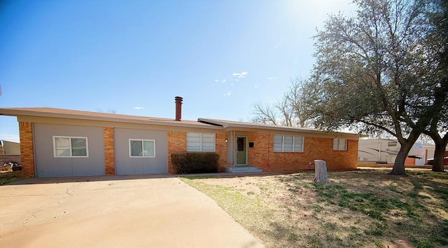 single story home featuring brick siding