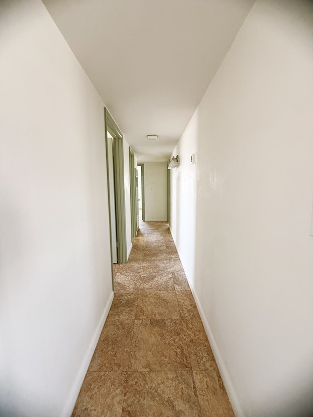 corridor featuring baseboards