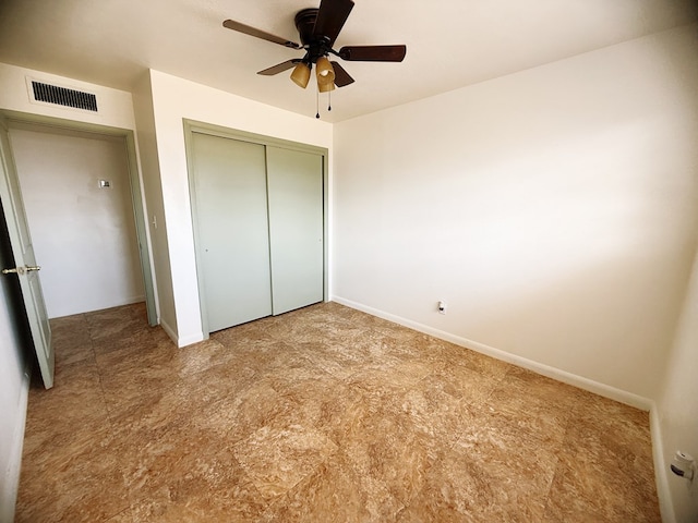 unfurnished bedroom featuring baseboards, visible vents, and a closet