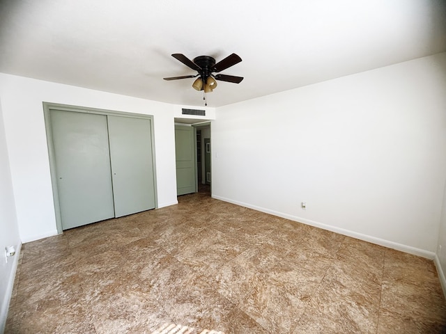 unfurnished bedroom with a closet, visible vents, ceiling fan, and baseboards