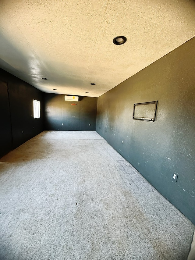 carpeted spare room with a textured ceiling