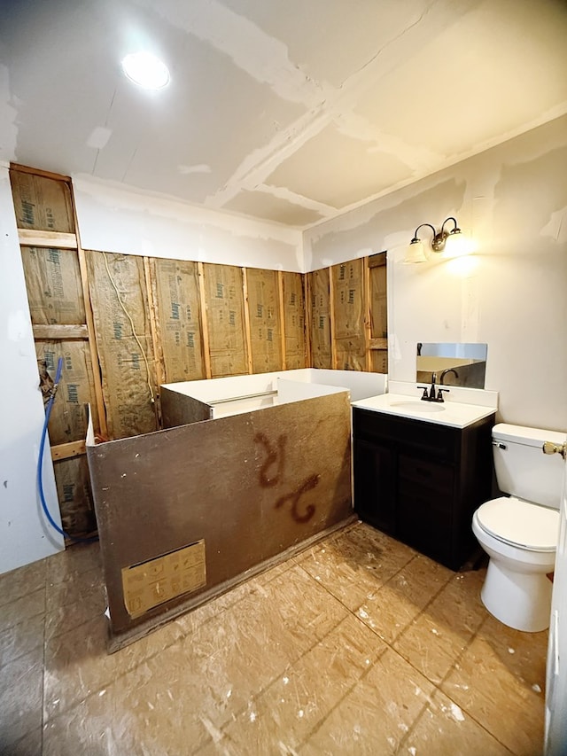 full bath featuring toilet, vanity, and a washtub