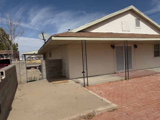 view of side of property with fence and a patio