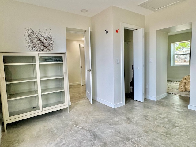 unfurnished bedroom featuring concrete floors