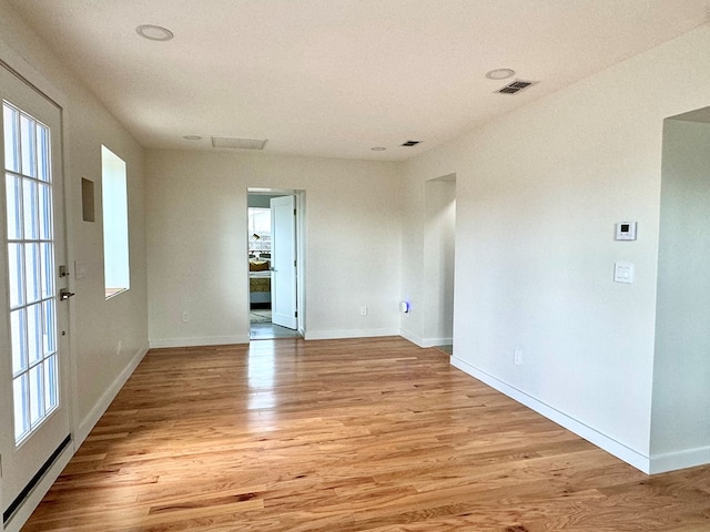 spare room featuring light hardwood / wood-style floors