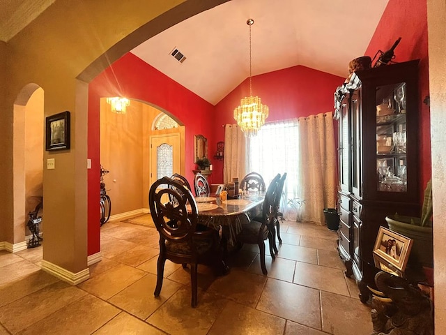 tiled dining room featuring a notable chandelier and lofted ceiling