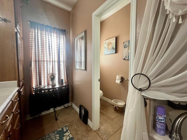 bathroom with tile patterned floors and toilet