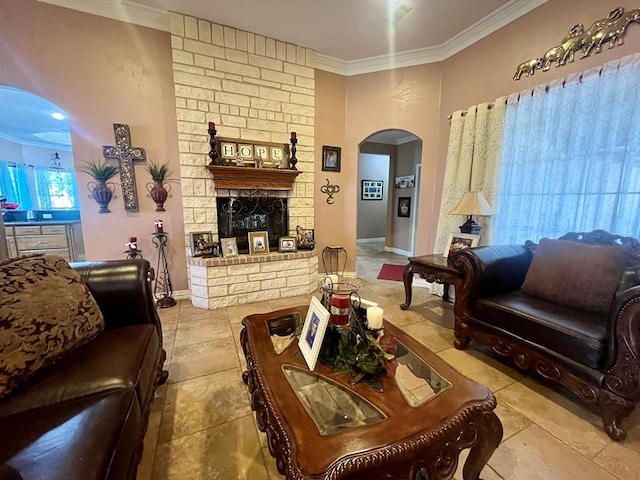 living room featuring crown molding and a fireplace