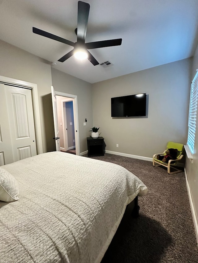 bedroom with a closet, ceiling fan, and carpet