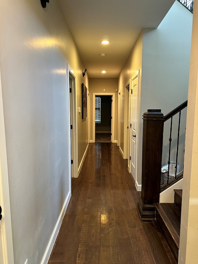 corridor with dark hardwood / wood-style flooring