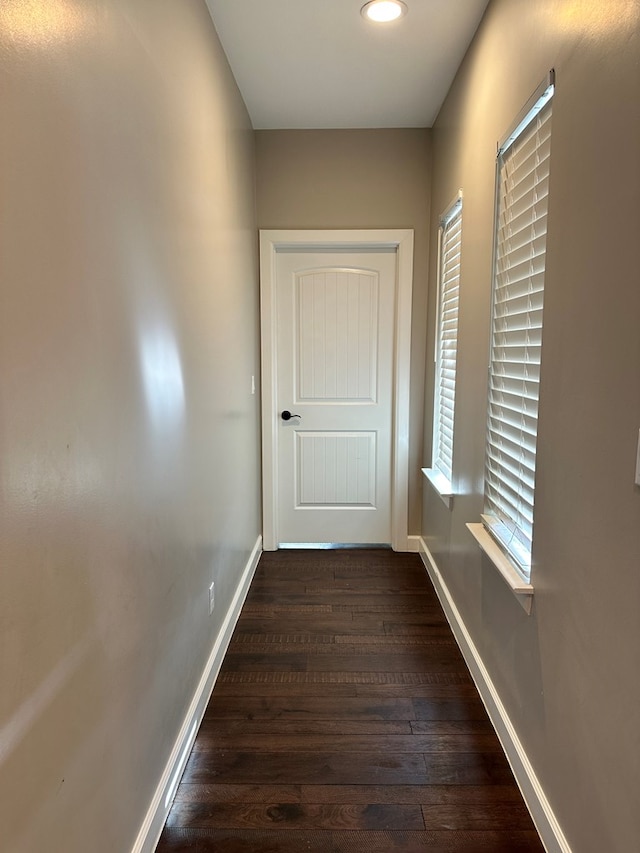 hallway with dark wood-type flooring