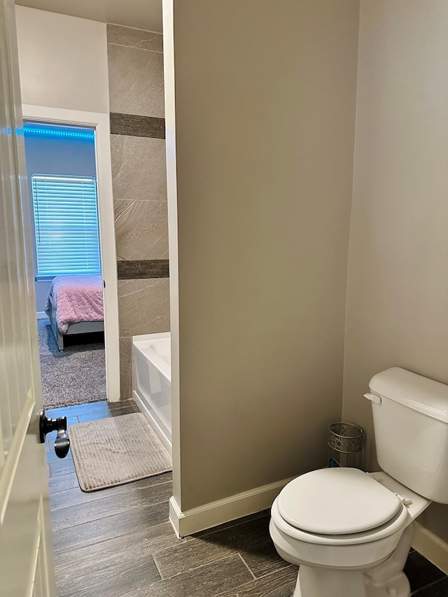 bathroom with a bath and toilet