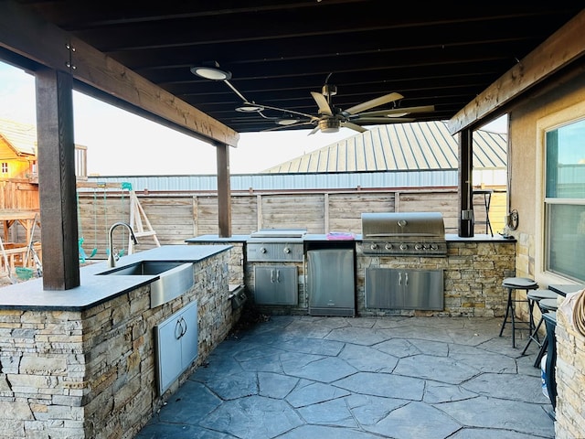 view of patio / terrace featuring area for grilling, sink, grilling area, and ceiling fan