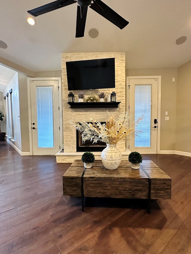 living room with ceiling fan, dark hardwood / wood-style floors, and a fireplace