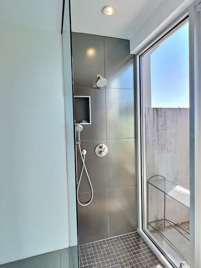 bathroom featuring a tile shower and tile patterned flooring