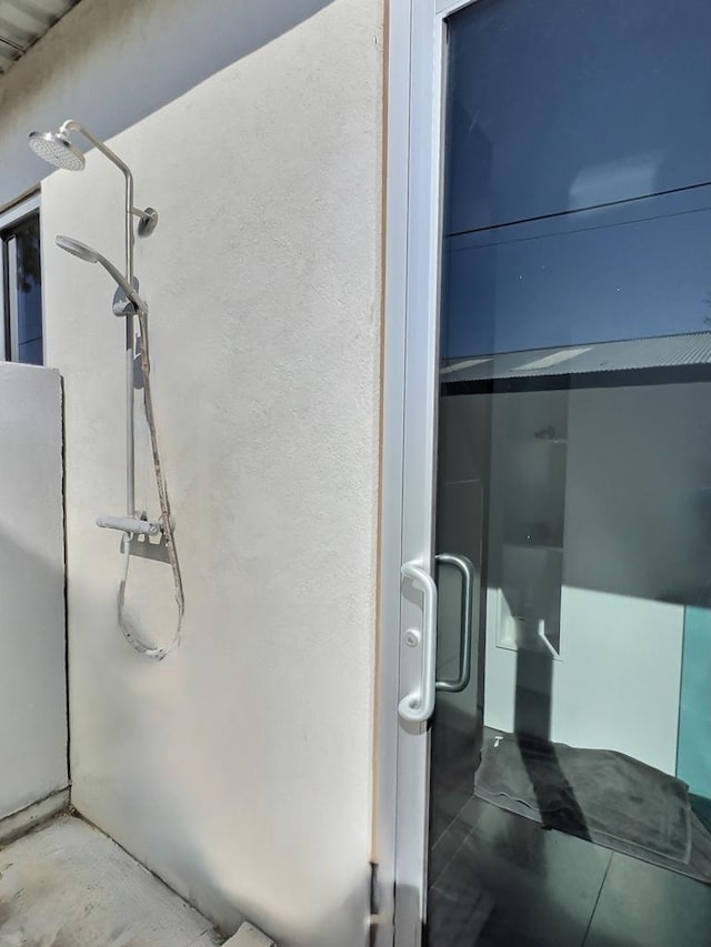 interior space featuring concrete flooring and walk in shower