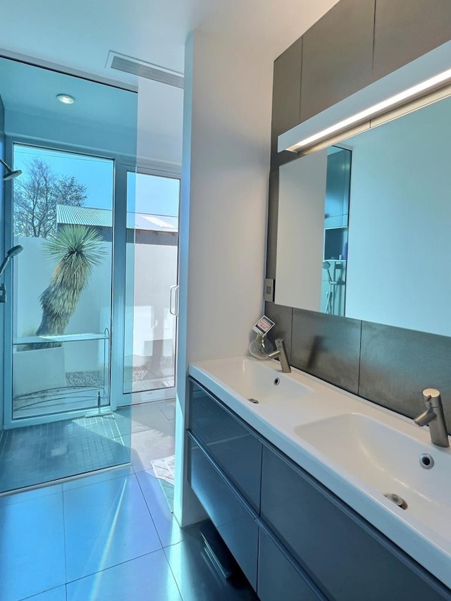 bathroom featuring vanity, tile patterned floors, and a shower with shower door