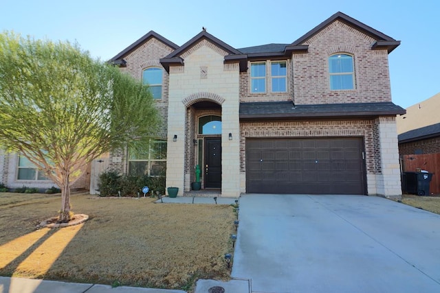 view of front of house with brick siding, driveway, and a garage