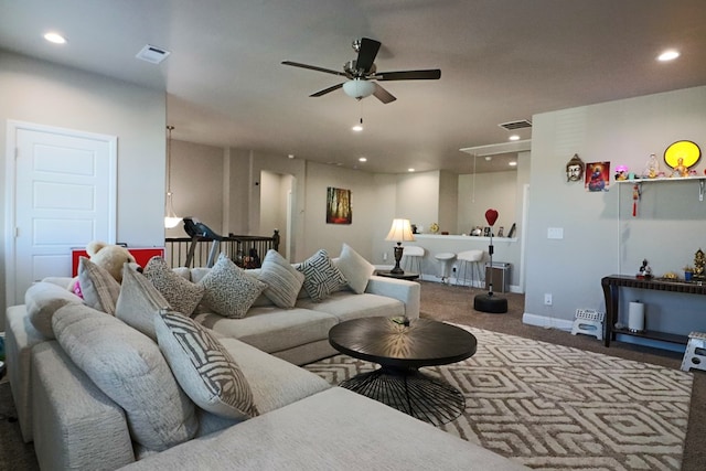 living room featuring visible vents, a ceiling fan, recessed lighting, carpet floors, and attic access