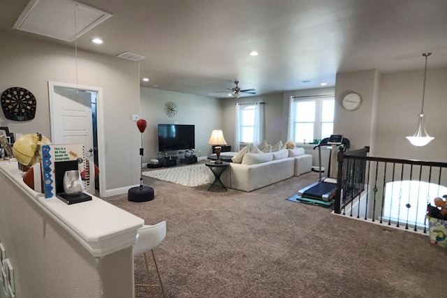 living area with carpet, visible vents, attic access, recessed lighting, and ceiling fan