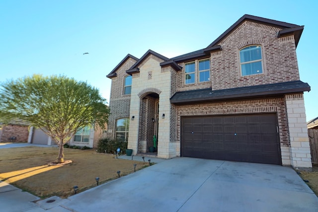 view of front of home with concrete driveway, an attached garage, brick siding, and stone siding