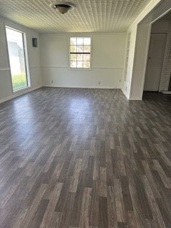 unfurnished room featuring a fireplace and dark wood-type flooring