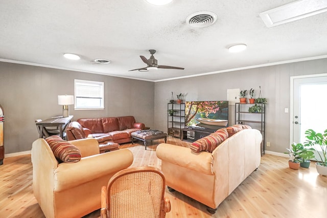 living room featuring light hardwood / wood-style flooring, ceiling fan, and crown molding