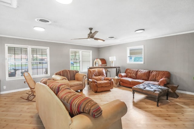 living room with ceiling fan, ornamental molding, and light hardwood / wood-style flooring