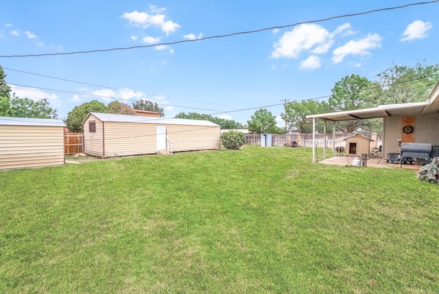 view of yard featuring a storage unit and a patio area