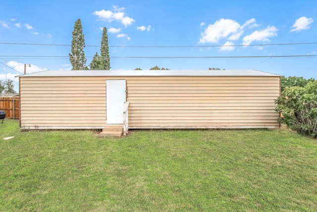 view of outbuilding with a yard