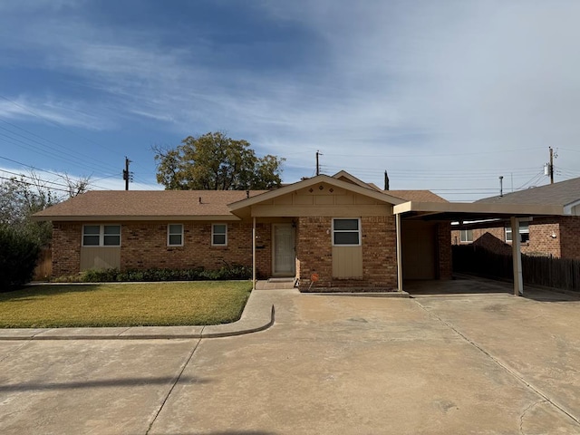 ranch-style house featuring a front lawn and a carport