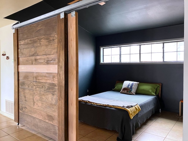 bedroom featuring light tile patterned floors