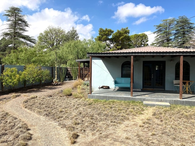 back of property featuring a patio area and french doors