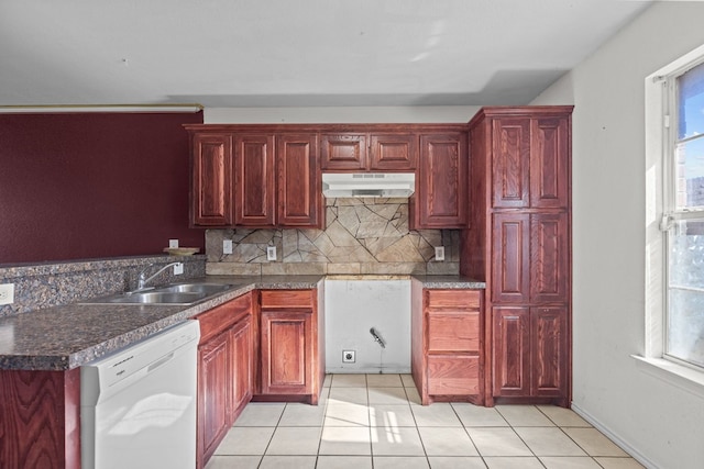 kitchen featuring tasteful backsplash, dishwasher, sink, and light tile patterned flooring