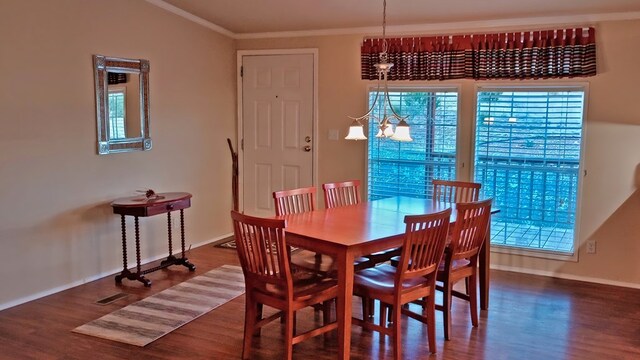 dining space featuring hardwood / wood-style floors, an inviting chandelier, and ornamental molding