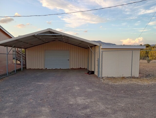 view of garage at dusk