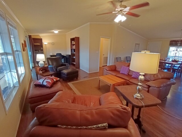 living room with hardwood / wood-style floors, ceiling fan, lofted ceiling, and ornamental molding