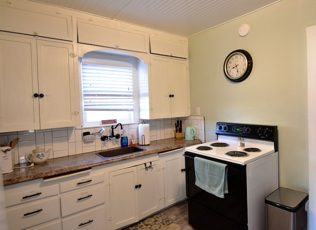 kitchen featuring dark hardwood / wood-style flooring, tasteful backsplash, sink, electric range, and white cabinetry