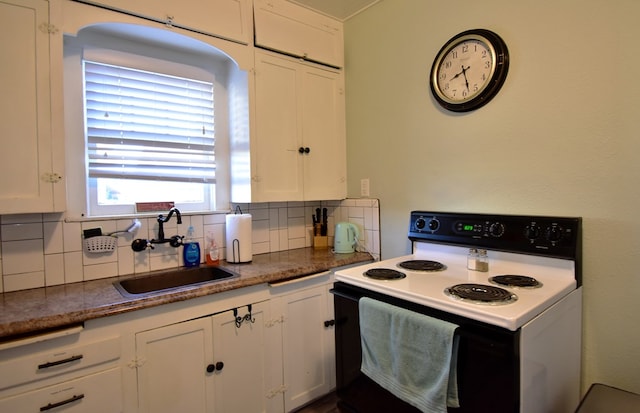 kitchen featuring decorative backsplash, sink, white cabinets, and white electric range oven