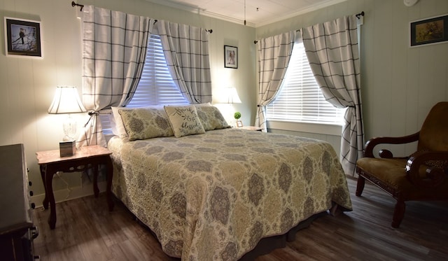 bedroom with hardwood / wood-style flooring and crown molding