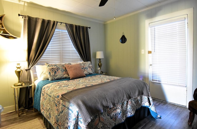 bedroom featuring hardwood / wood-style flooring, ceiling fan, and crown molding