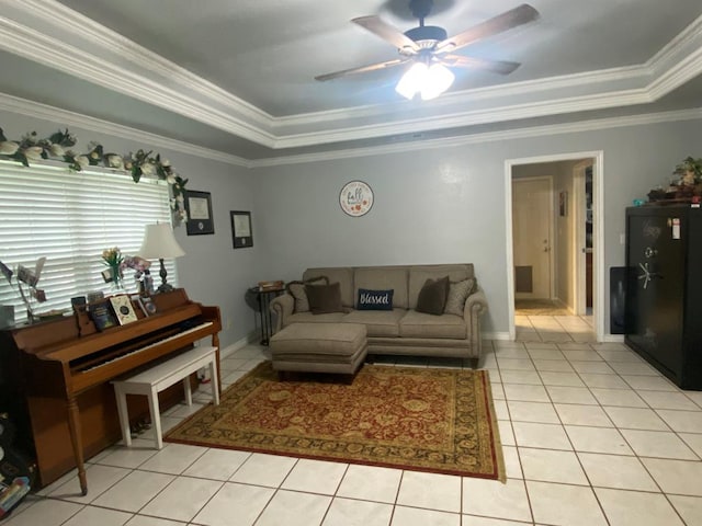 living room featuring crown molding, light tile patterned floors, ceiling fan, and a raised ceiling