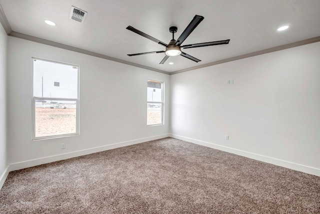 carpeted spare room featuring a ceiling fan, baseboards, visible vents, recessed lighting, and ornamental molding