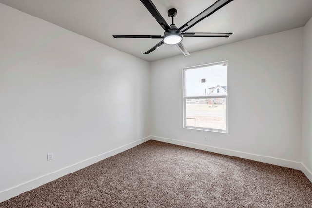 carpeted empty room with baseboards and a ceiling fan