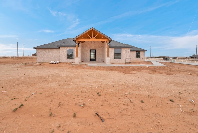 view of front of property featuring roof with shingles