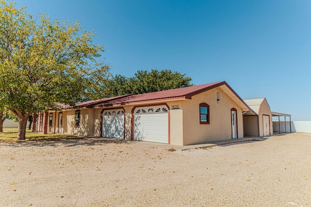 view of front of property featuring a garage and a carport