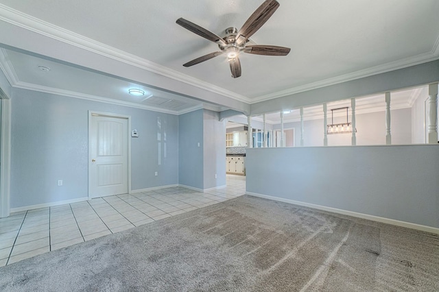 carpeted spare room with ceiling fan and ornamental molding