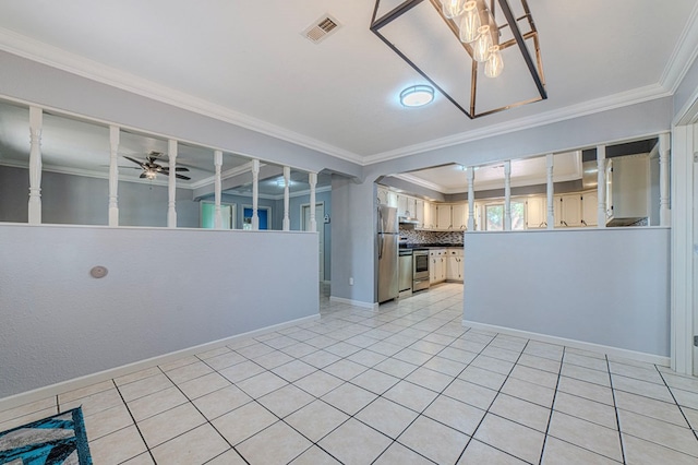 tiled spare room with ceiling fan and crown molding